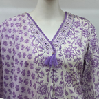 Soft cream and lavender cotton churidar set with floral print, dupatta and mirror-style neckline. Available at Beleza Calicut.