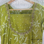 Leaf green silk blend 2-piece set with ivory botanical print, embellished deep neckline, three-quarter sleeves and matching plain bottom.
