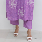 Purple floral dress with matching pants on a white background