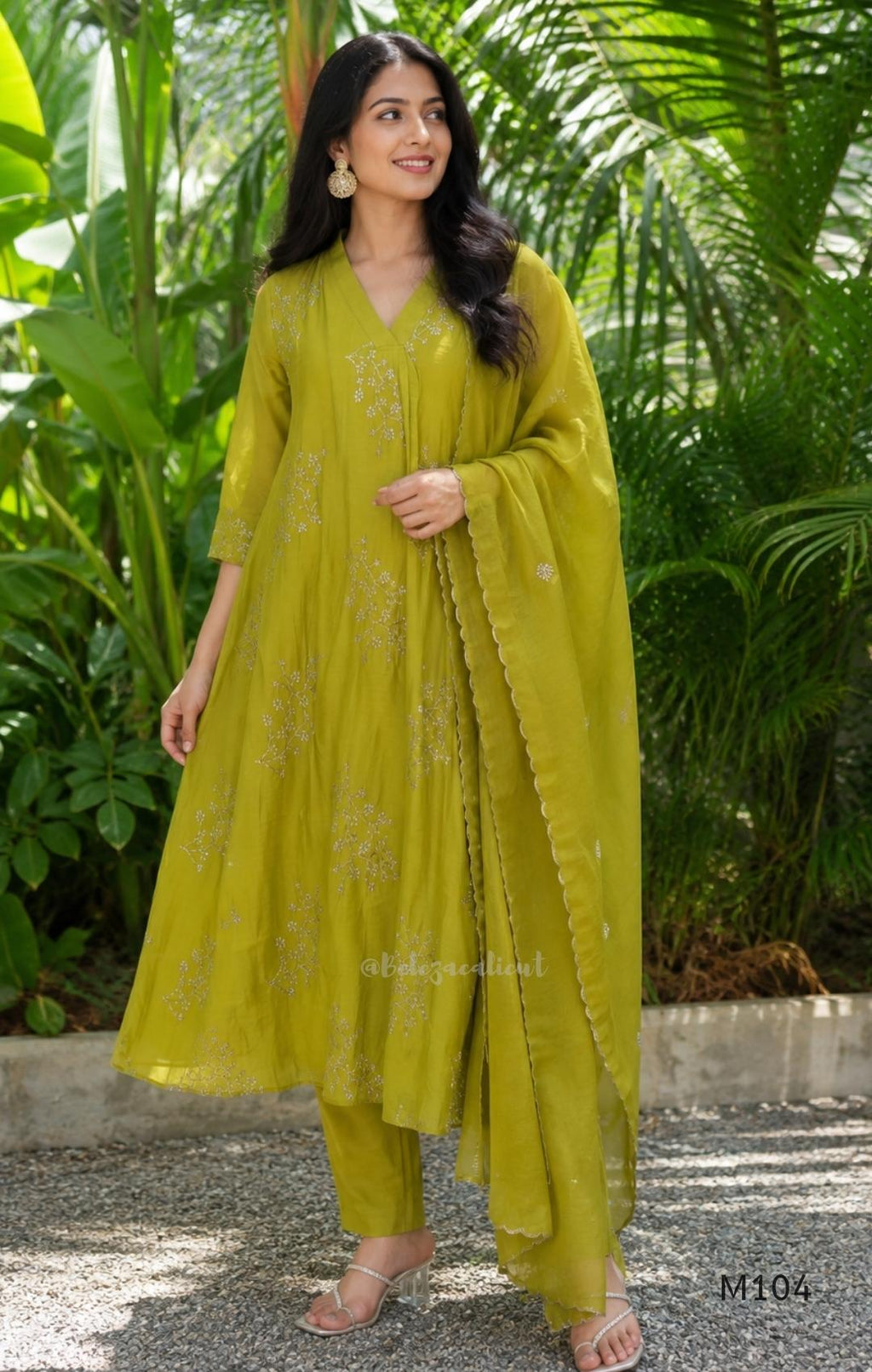 Lime green Mul Chanderi A-line churidar set with silver-toned floral vine work and matching dupatta.