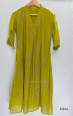 Lime green Mul Chanderi A-line churidar set with silver-toned floral vine work and matching dupatta.