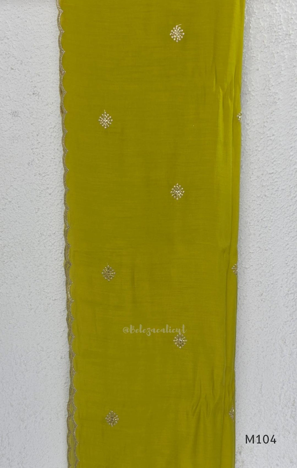 Lime green Mul Chanderi A-line churidar set with silver-toned floral vine work and matching dupatta.