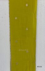 Lime green Mul Chanderi A-line churidar set with silver-toned floral vine work and matching dupatta.