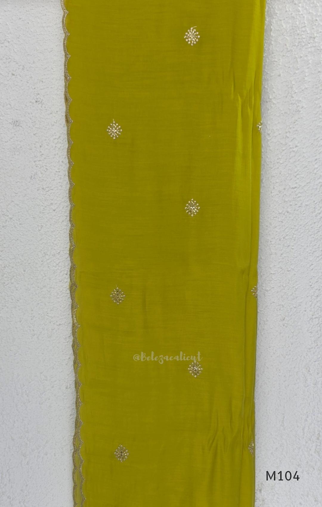 Lime green Mul Chanderi A-line churidar set with silver-toned floral vine work and matching dupatta.