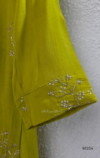 Lime green Mul Chanderi A-line churidar set with silver-toned floral vine work and matching dupatta.