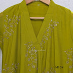 Lime green Mul Chanderi A-line churidar set with silver-toned floral vine work and matching dupatta.
