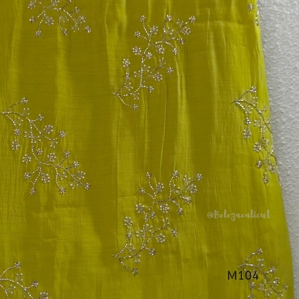 Lime green Mul Chanderi A-line churidar set with silver-toned floral vine work and matching dupatta.