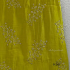 Lime green Mul Chanderi A-line churidar set with silver-toned floral vine work and matching dupatta.