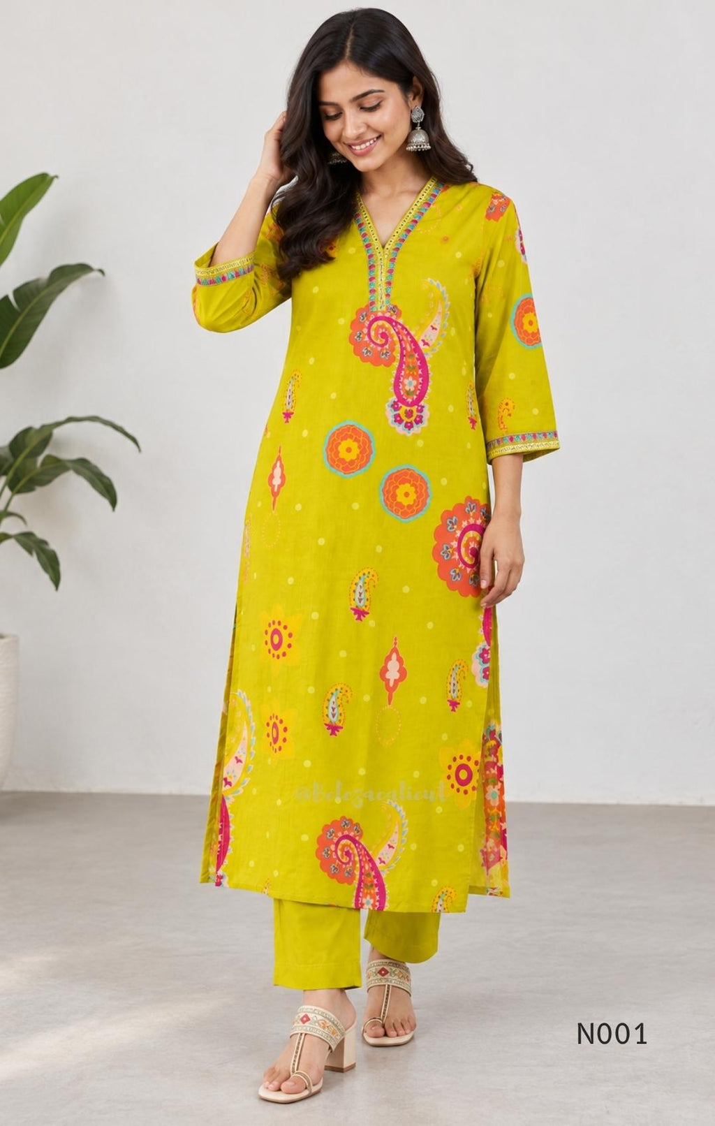 Lime yellow cotton top and bottom set with multicolour paisley and floral print and decorative V-neck trim.