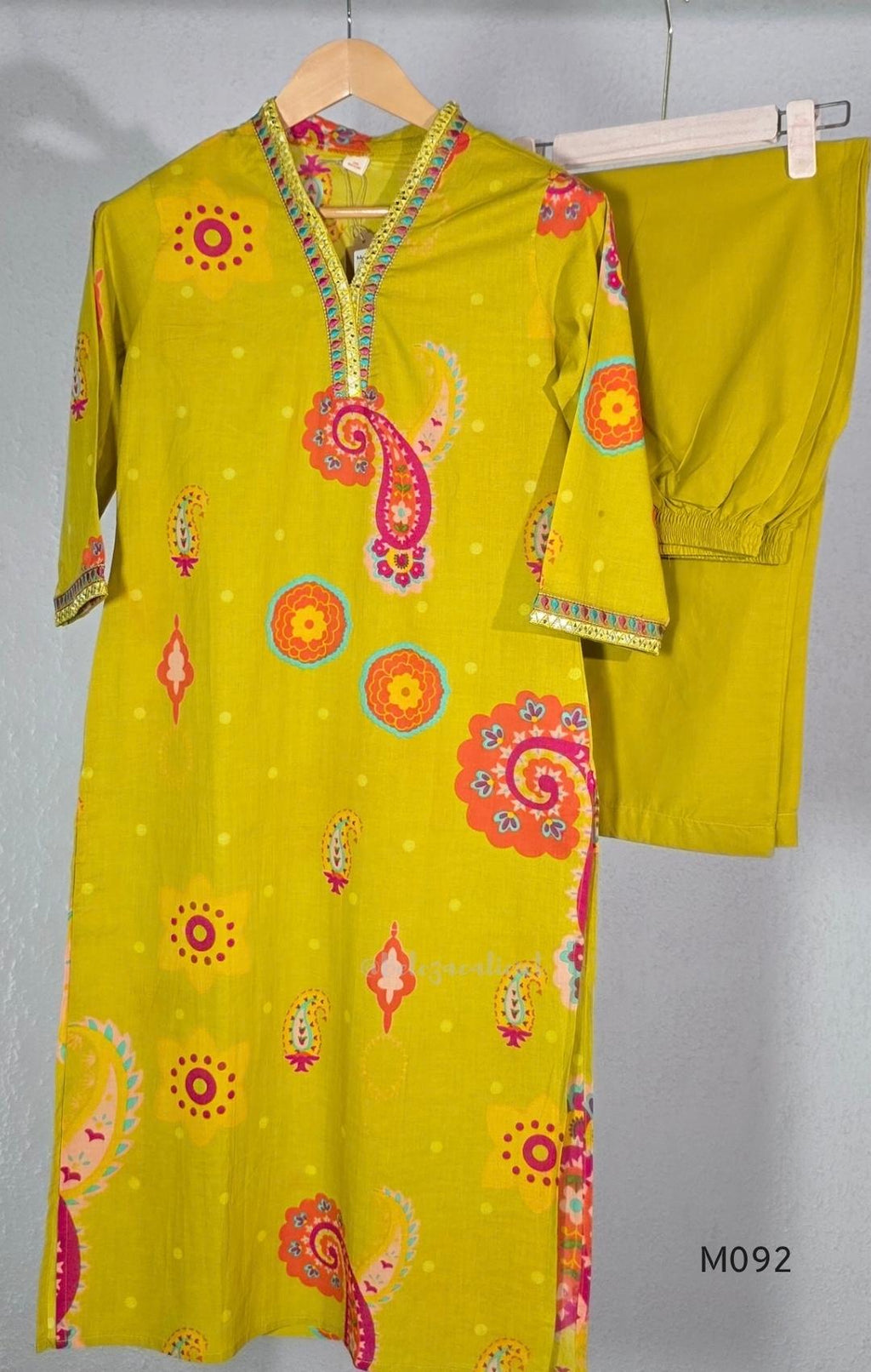 Lime yellow cotton top and bottom set with multicolour paisley and floral print and decorative V-neck trim.