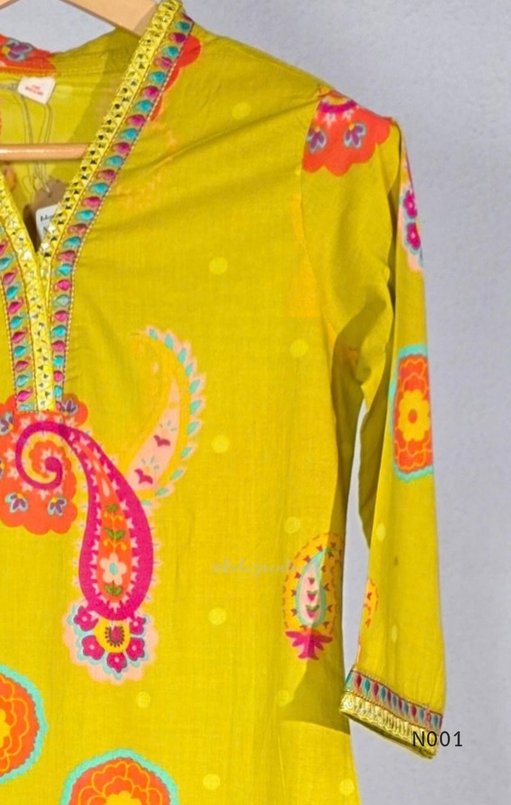 Lime yellow cotton top and bottom set with multicolour paisley and floral print and decorative V-neck trim.