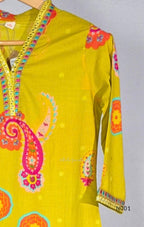 Lime yellow cotton top and bottom set with multicolour paisley and floral print and decorative V-neck trim.