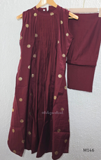 Deep maroon Vertigan silk co-ord set with pleated A-line top, gold circular side motifs and matching straight pants.