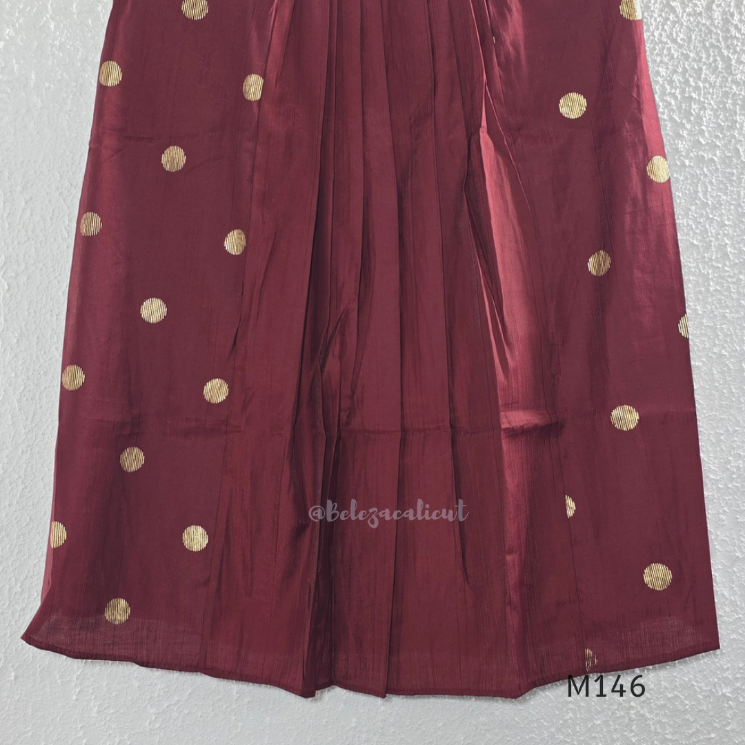Deep maroon Vertigan silk co-ord set with pleated A-line top, gold circular side motifs and matching straight pants.