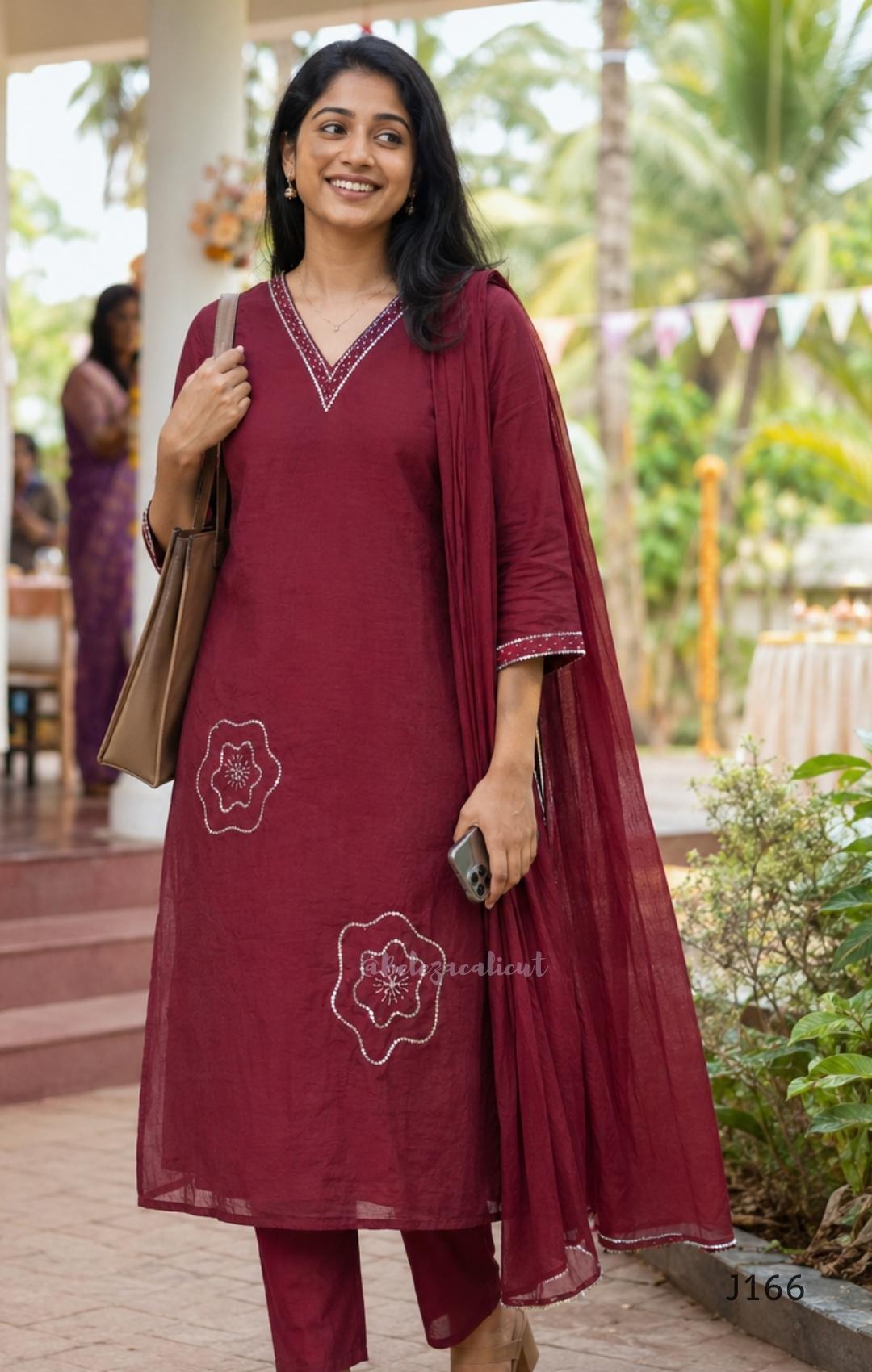 Maroon mul chanderi churidar set with silver sequin neckline, sleeve detailing, matching bottom and dupatta at Beleza Calicut.