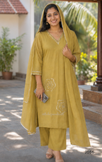 Muted mustard mul chanderi churidar suit set with silver sequin floral work, matching dupatta and bottom at Beleza Calicut.