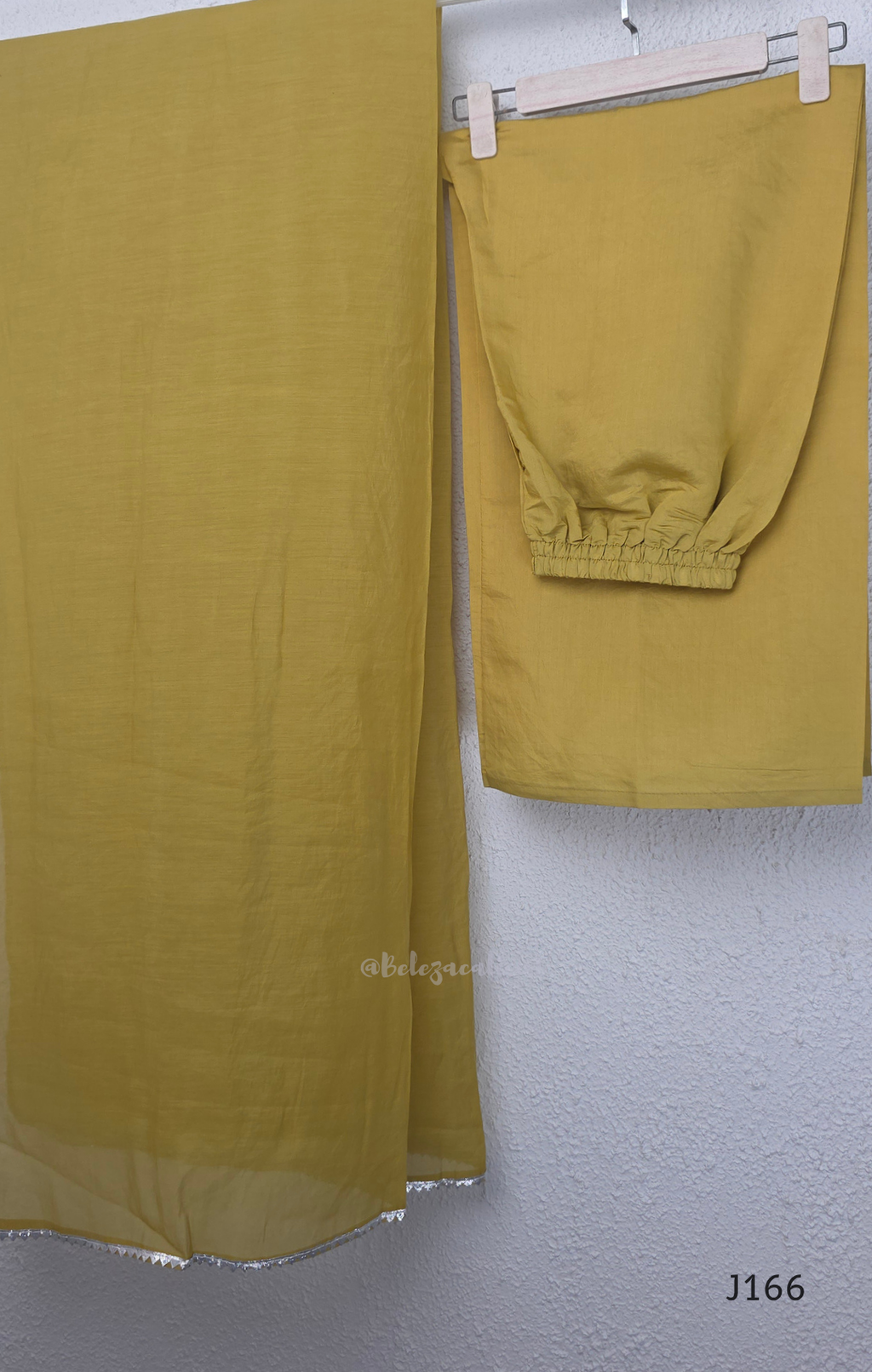 Muted mustard mul chanderi churidar suit set with silver sequin floral work, matching dupatta and bottom at Beleza Calicut.