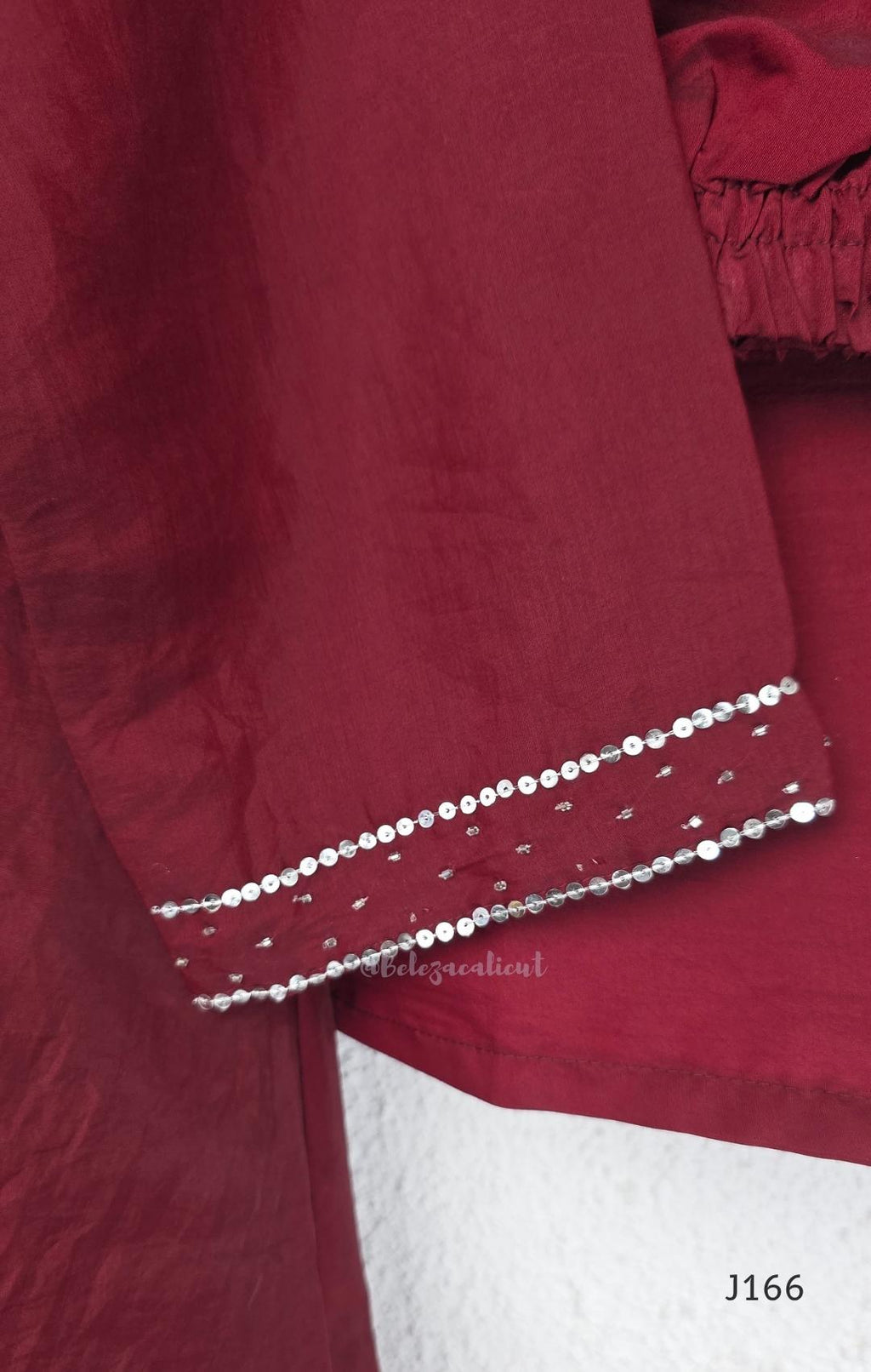 Maroon mul chanderi churidar set with silver sequin neckline, sleeve detailing, matching bottom and dupatta at Beleza Calicut.