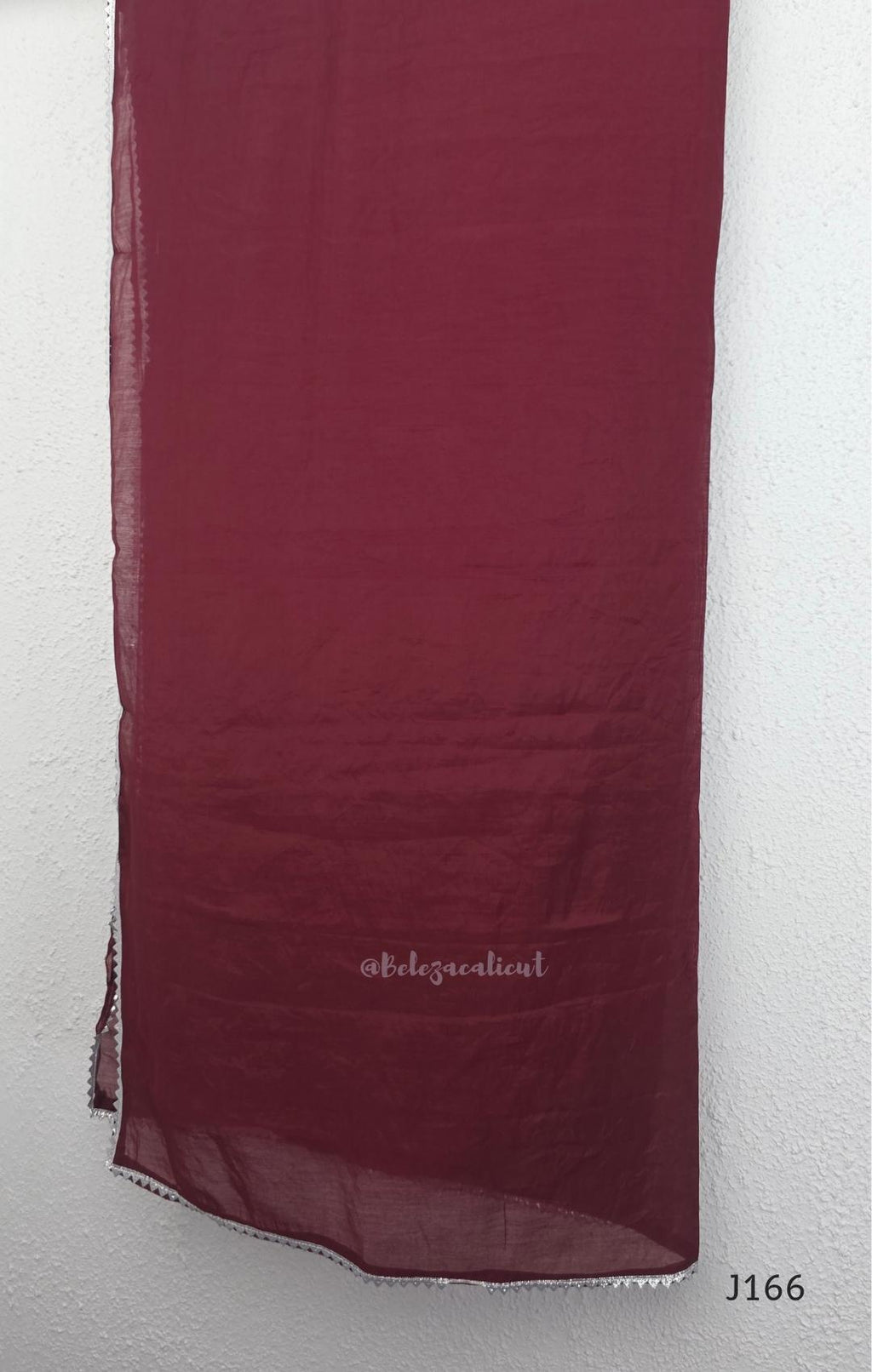 Maroon mul chanderi churidar set with silver sequin neckline, sleeve detailing, matching bottom and dupatta at Beleza Calicut.
