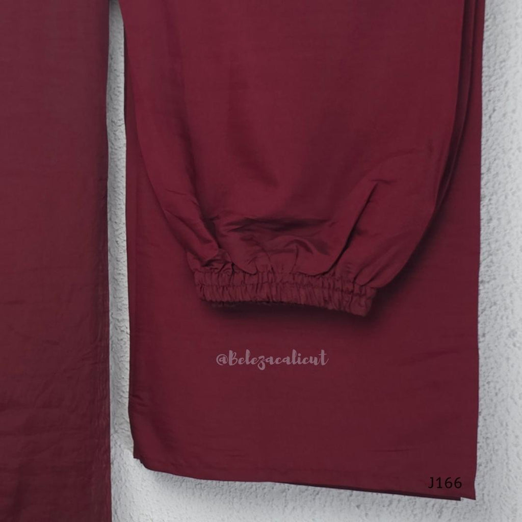 Maroon mul chanderi churidar set with silver sequin neckline, sleeve detailing, matching bottom and dupatta at Beleza Calicut.