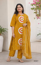 Mustard cotton 3-piece churidar set with abstract circle print kurta, matching printed dupatta and ankle-cuff bottom.