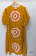 Mustard cotton 3-piece churidar set with abstract circle print kurta, matching printed dupatta and ankle-cuff bottom.