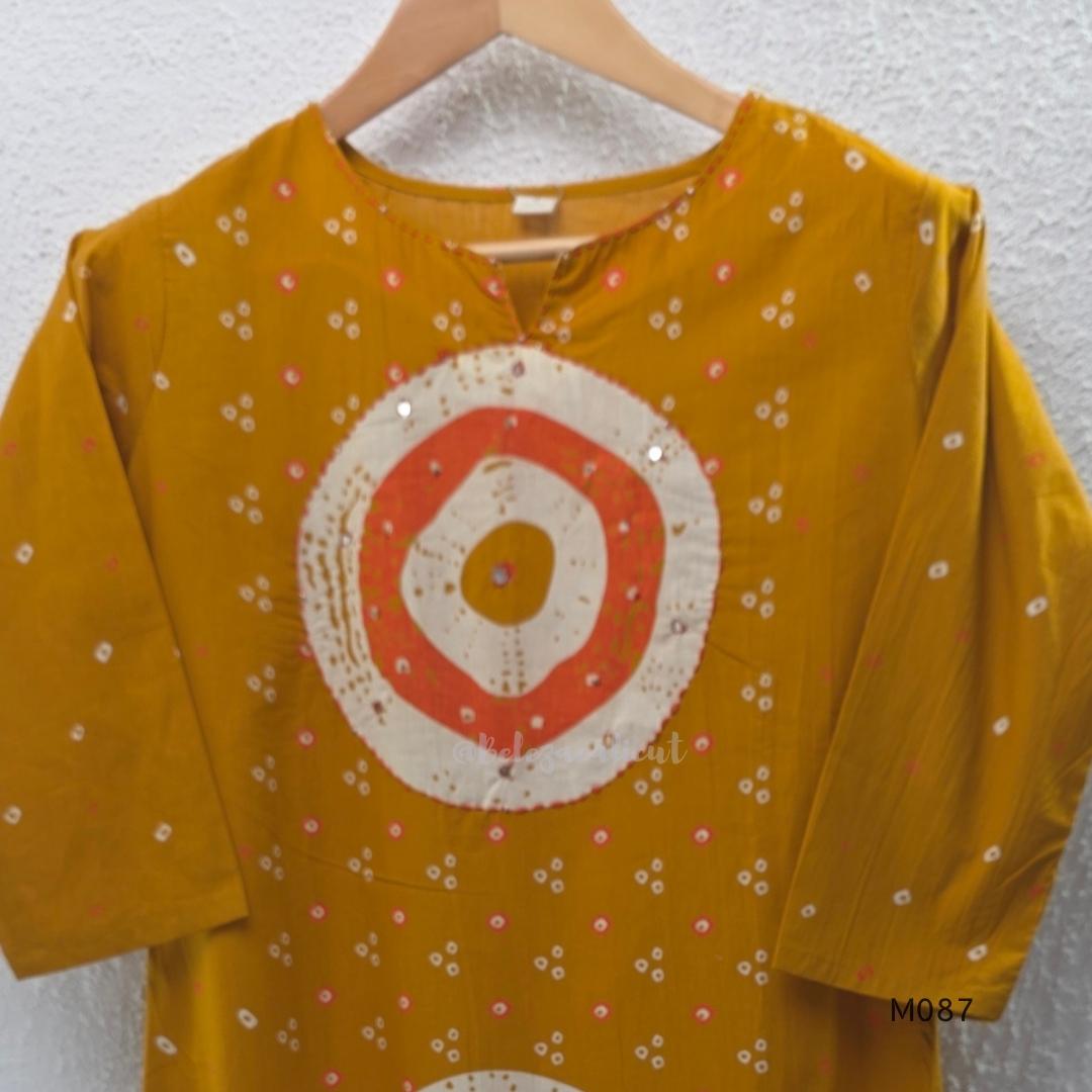 Mustard cotton 3-piece churidar set with abstract circle print kurta, matching printed dupatta and ankle-cuff bottom.