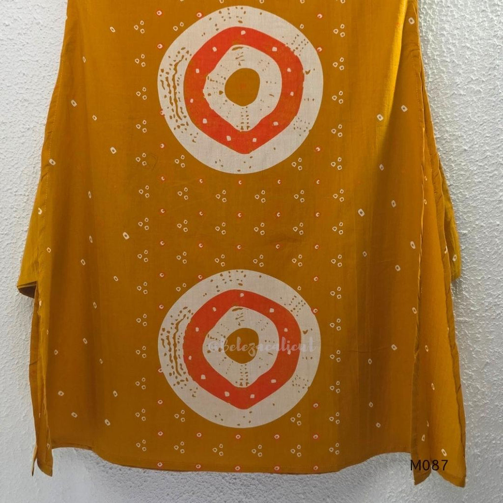 Mustard cotton 3-piece churidar set with abstract circle print kurta, matching printed dupatta and ankle-cuff bottom.