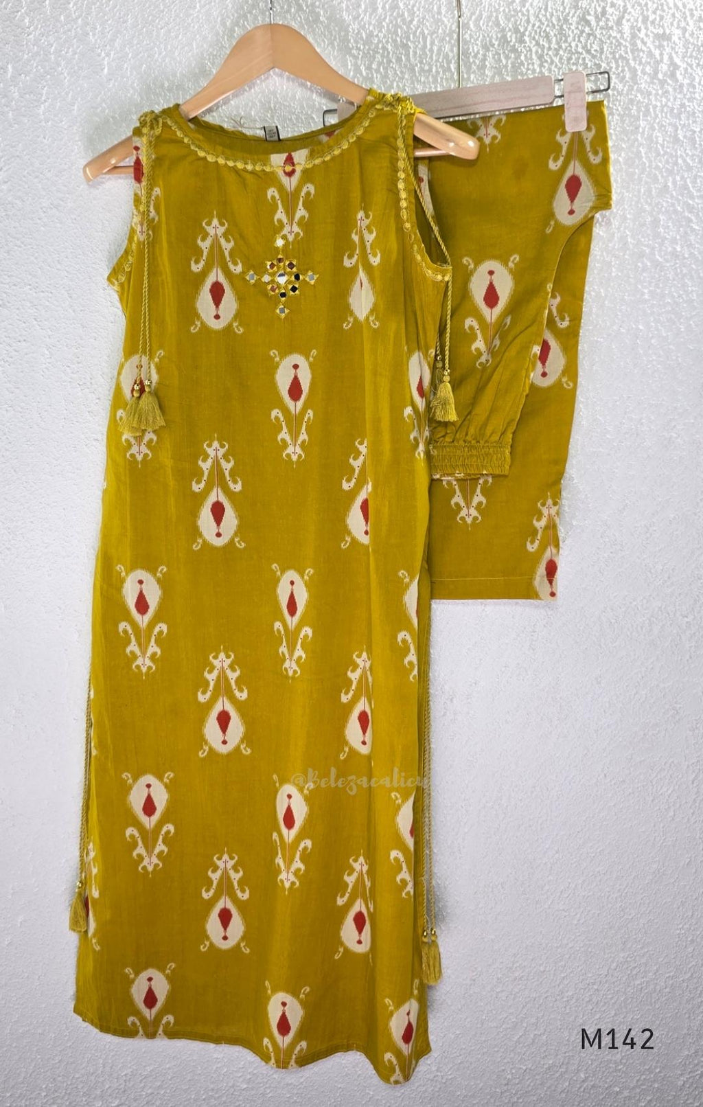 Mustard cotton top and bottom coord set with cream and rust motifs, tassel detailing and front mirror work.