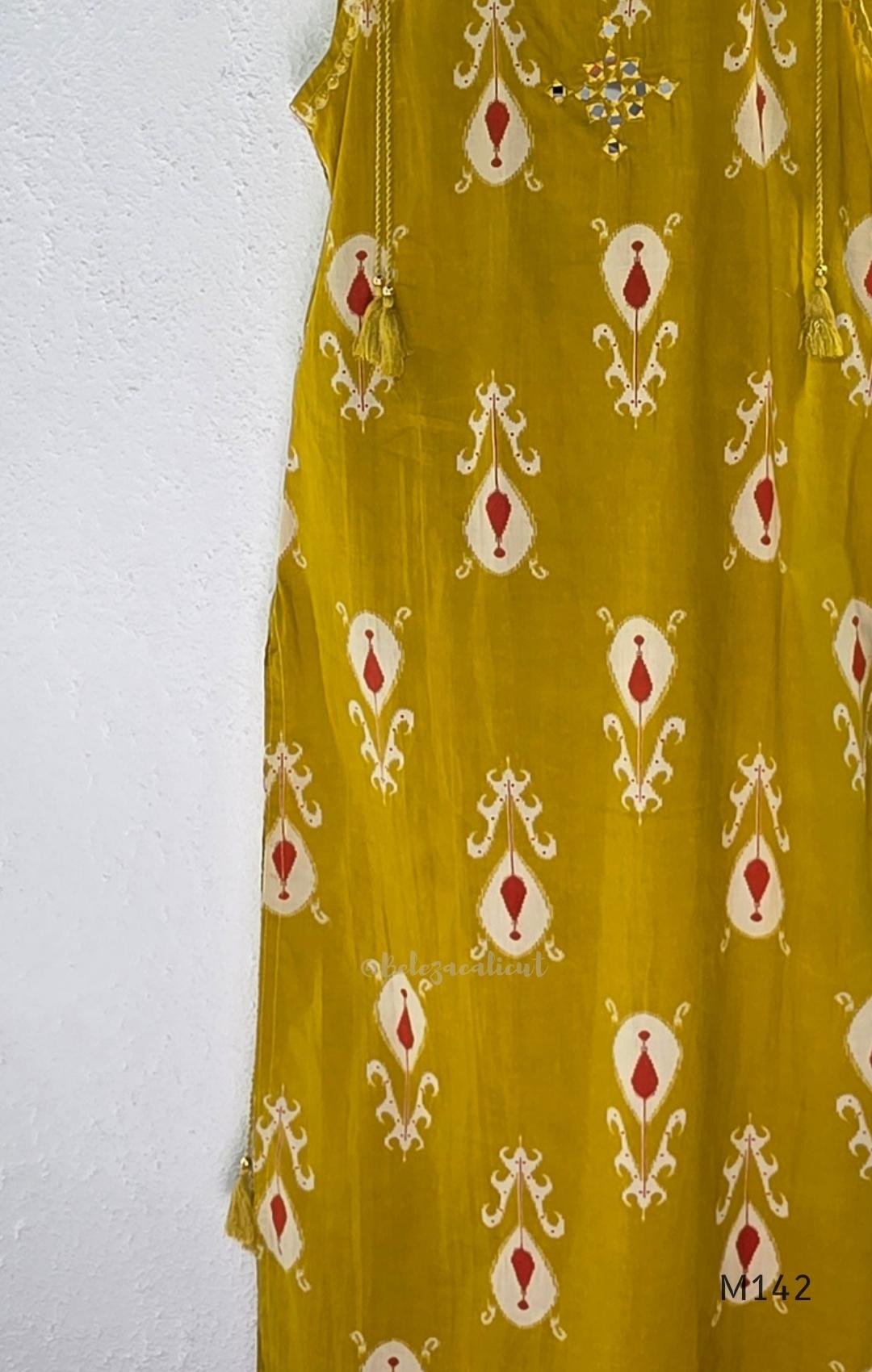 Mustard cotton top and bottom coord set with cream and rust motifs, tassel detailing and front mirror work.