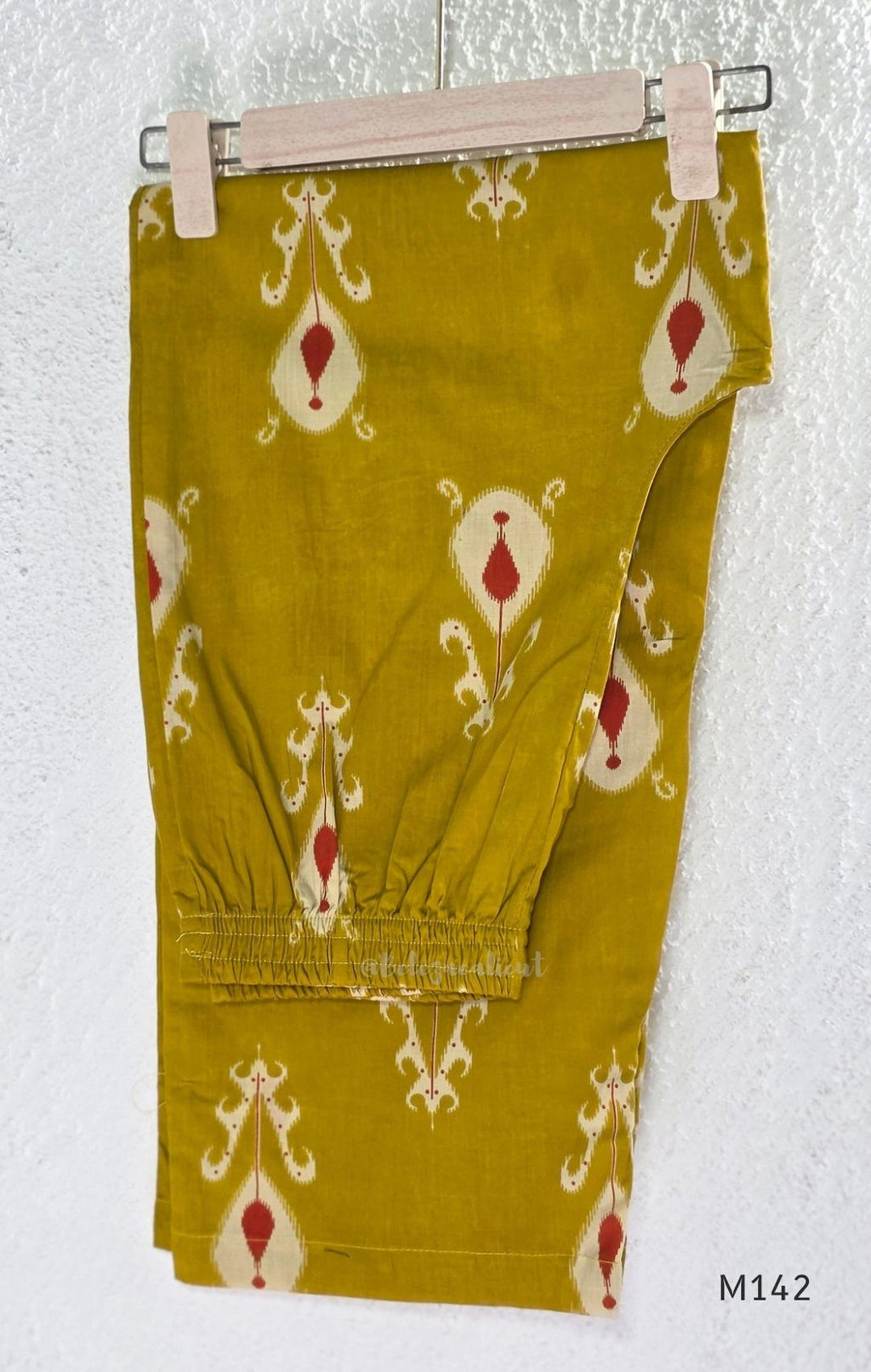 Mustard cotton top and bottom coord set with cream and rust motifs, tassel detailing and front mirror work.