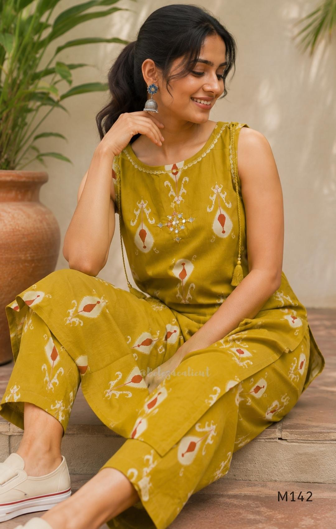 Mustard cotton top and bottom coord set with cream and rust motifs, tassel detailing and front mirror work.