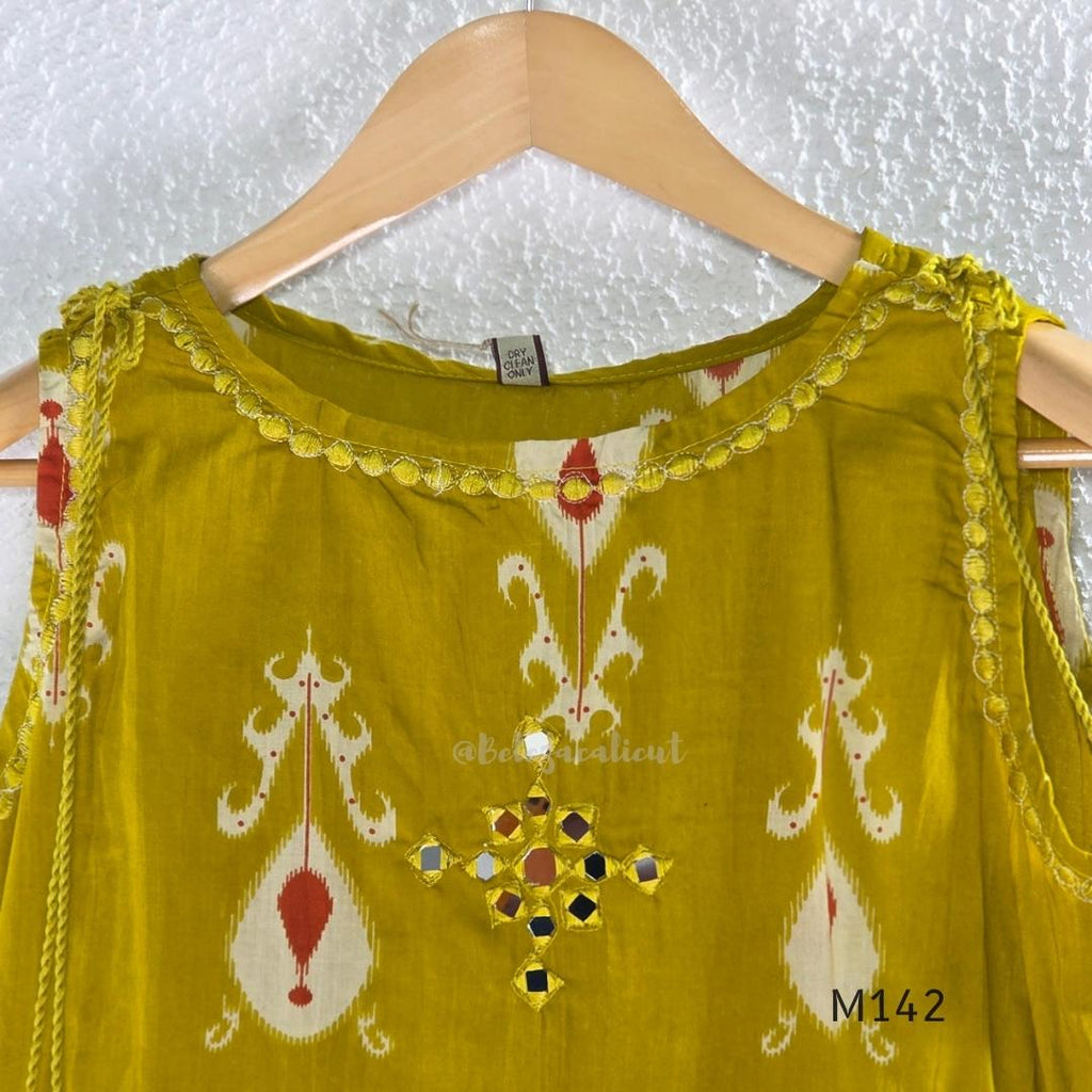 Mustard cotton top and bottom coord set with cream and rust motifs, tassel detailing and front mirror work.