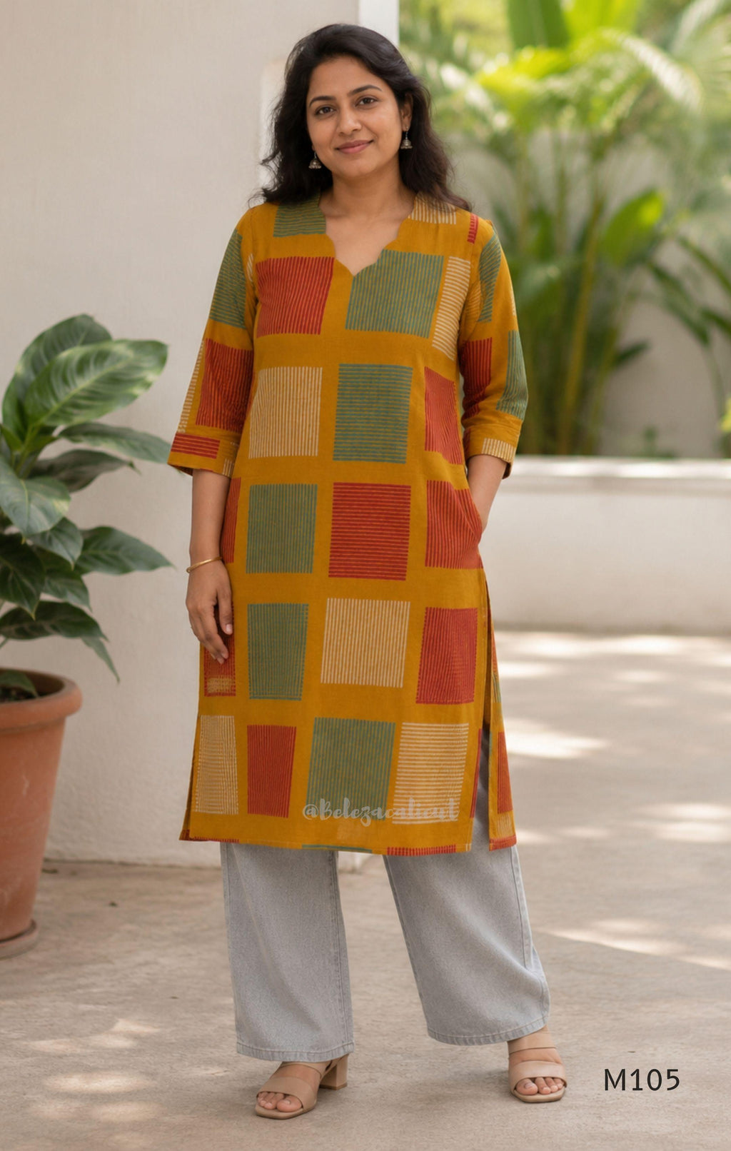 Warm mustard cotton long kurta with teal, deep pink and off-white striped rectangular motifs, V-neck and three-quarter sleeves.