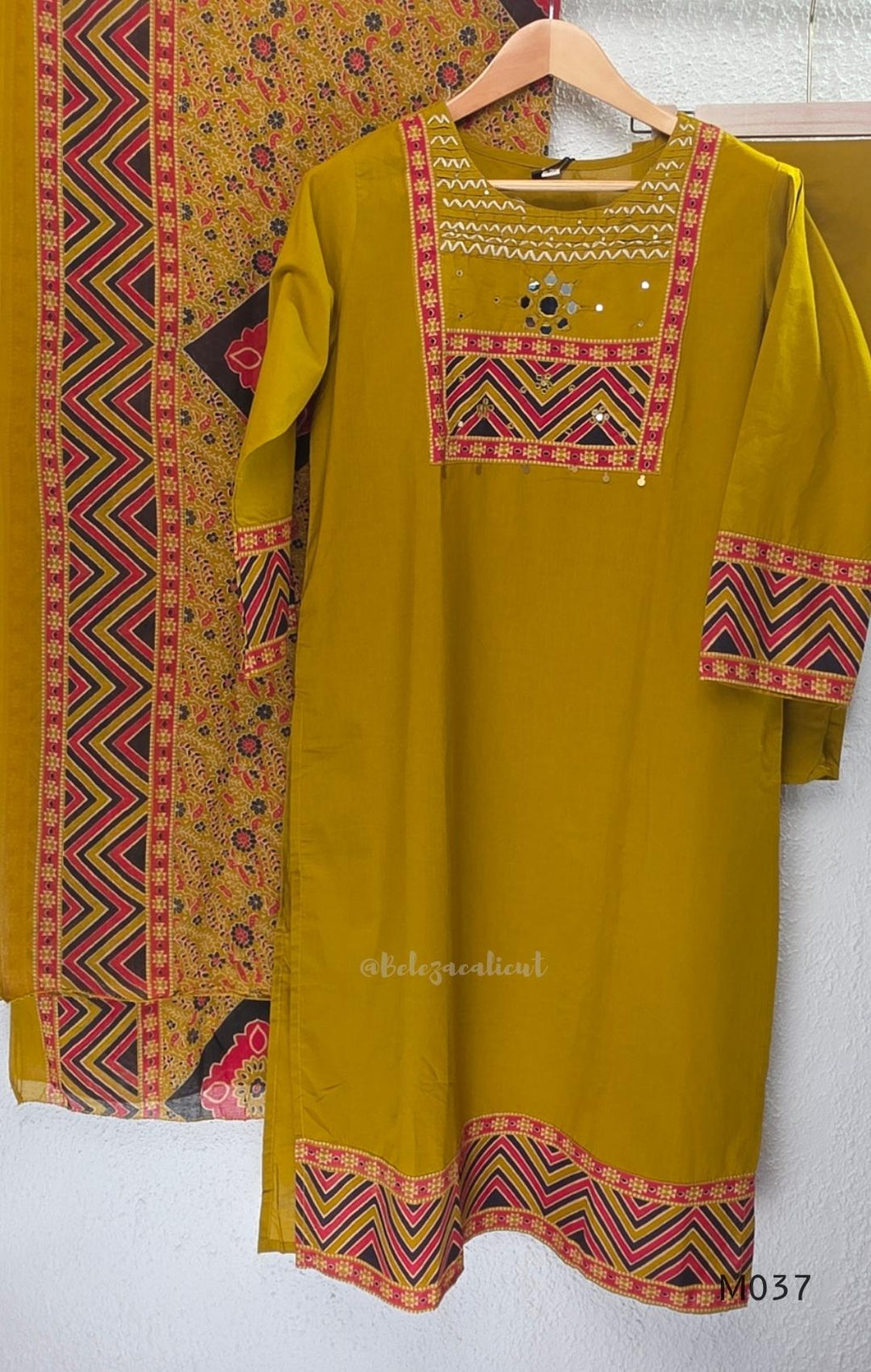 Mustard Jaipur cotton three-piece churidar set with mirror-detail yoke, printed borders and coordinated printed dupatta.
