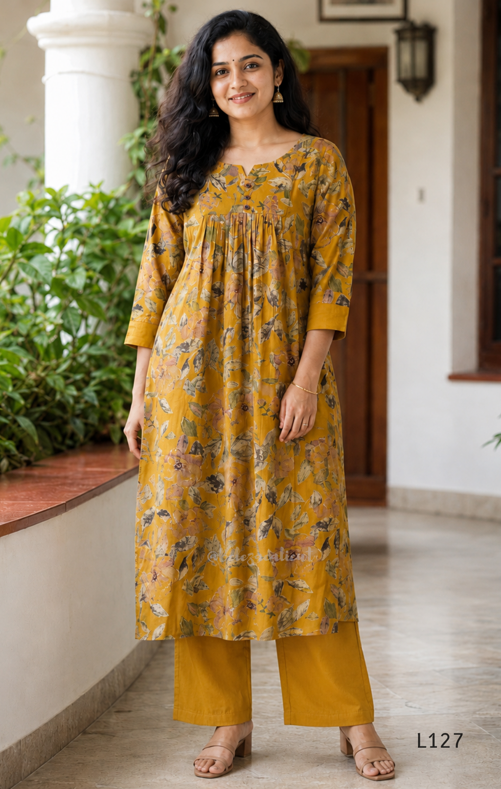 Mustard yellow silk blend 2-piece kurti set with floral print, gathered yoke, 3/4 sleeves, button detail, and matching bottom.
