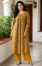 Mustard yellow silk blend 2-piece kurti set with floral print, gathered yoke, 3/4 sleeves, button detail, and matching bottom.