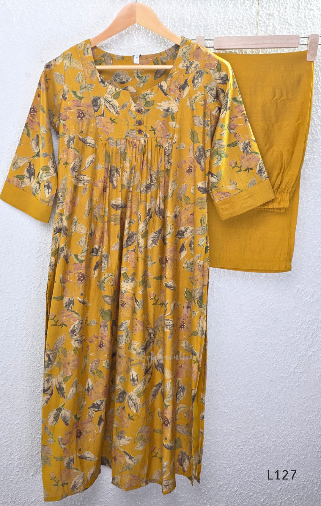 Mustard yellow silk blend 2-piece kurti set with floral print, gathered yoke, 3/4 sleeves, button detail, and matching bottom.