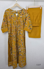 Mustard yellow silk blend 2-piece kurti set with floral print, gathered yoke, 3/4 sleeves, button detail, and matching bottom.