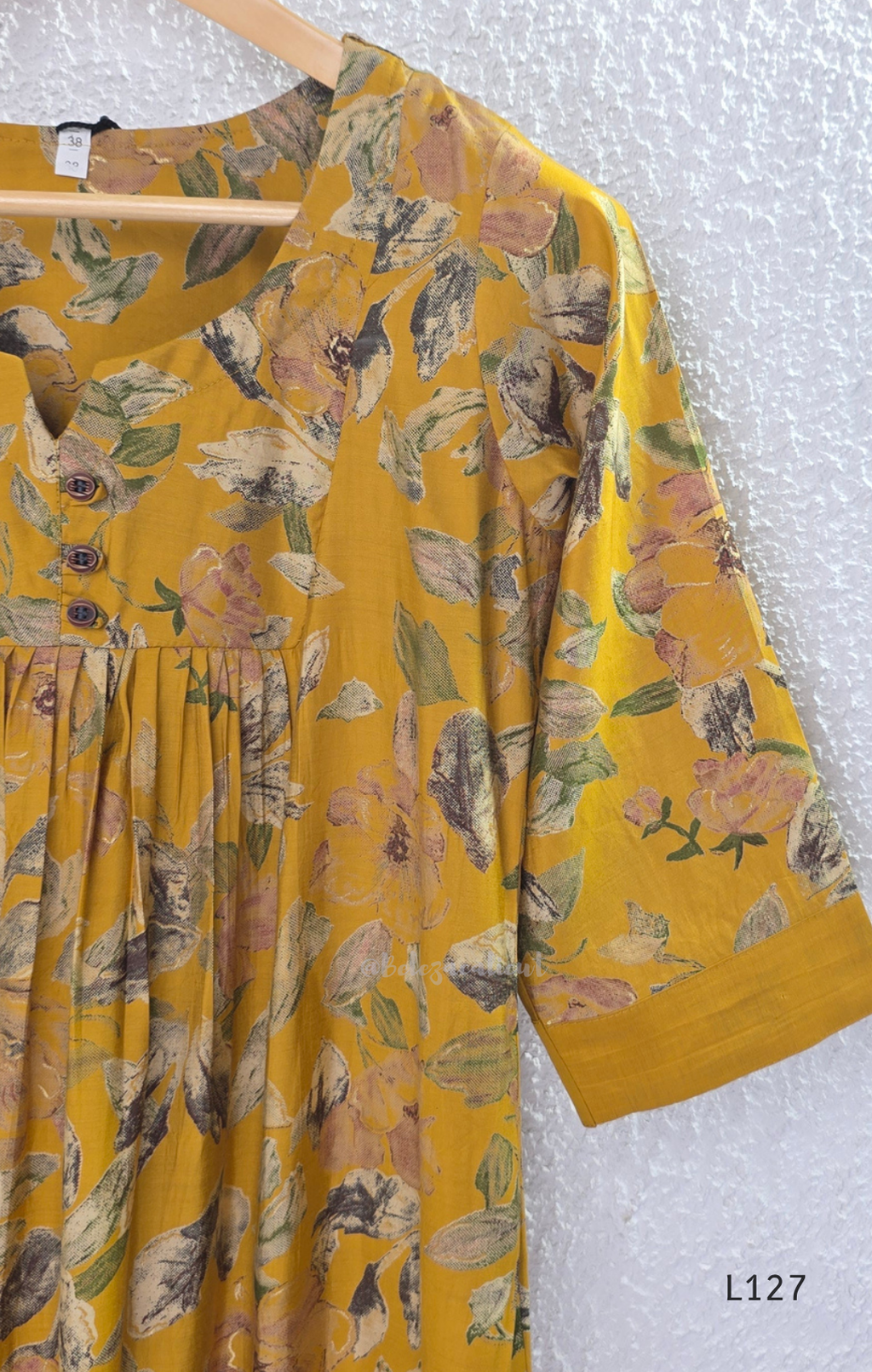 Mustard yellow silk blend 2-piece kurti set with floral print, gathered yoke, 3/4 sleeves, button detail, and matching bottom.