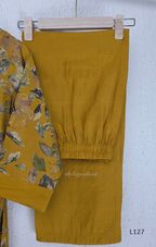 Mustard yellow silk blend 2-piece kurti set with floral print, gathered yoke, 3/4 sleeves, button detail, and matching bottom.