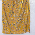 Mustard yellow silk blend 2-piece kurti set with floral print, gathered yoke, 3/4 sleeves, button detail, and matching bottom.