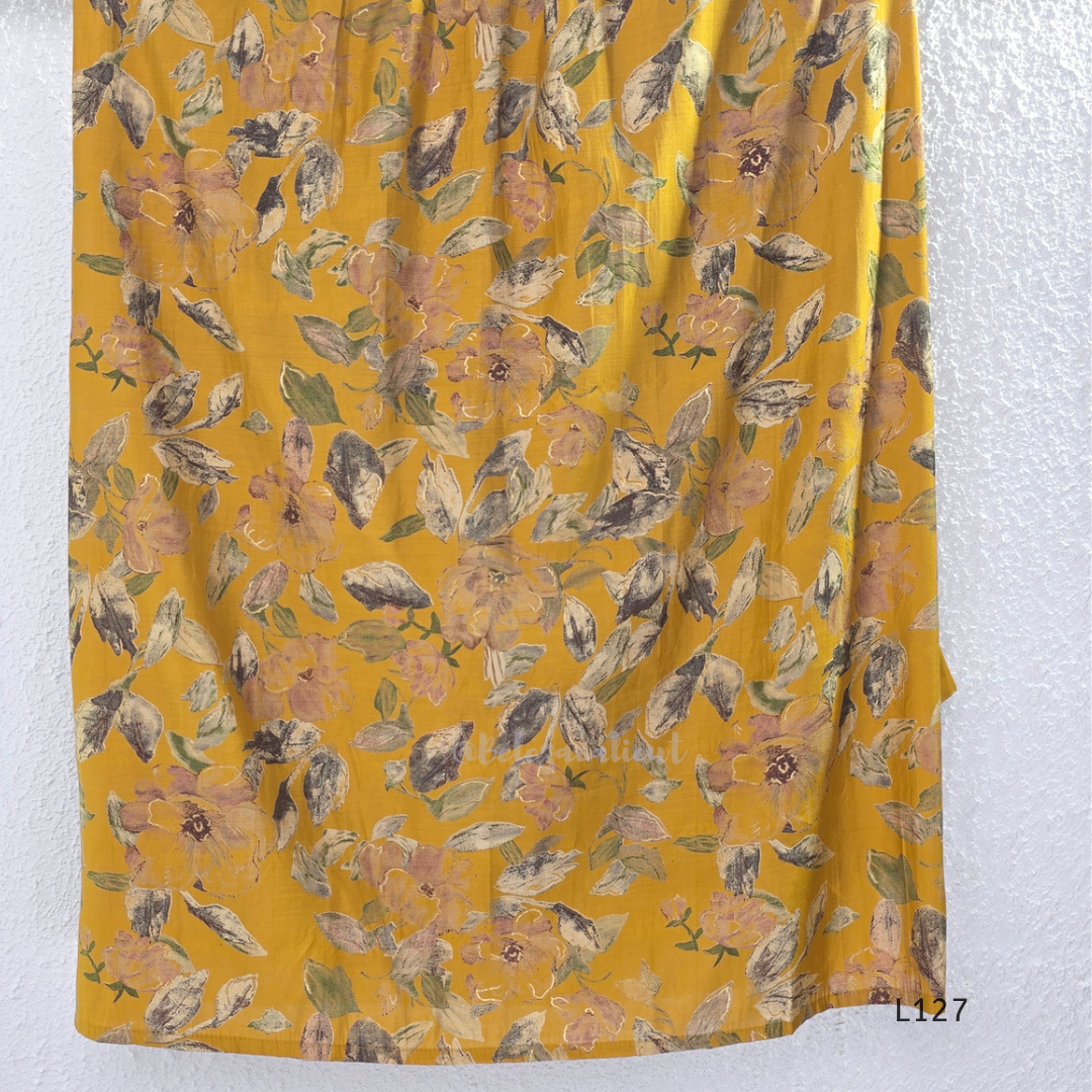 Mustard yellow silk blend 2-piece kurti set with floral print, gathered yoke, 3/4 sleeves, button detail, and matching bottom.