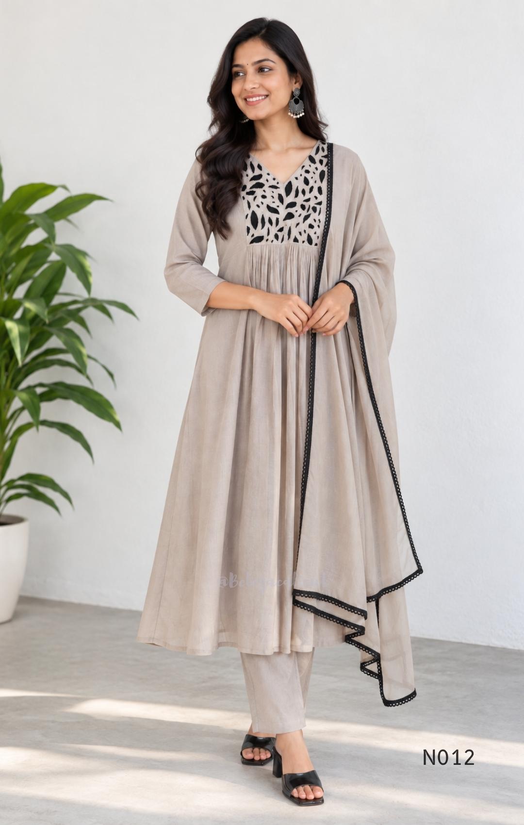 Muted ash-taupe Mul Chanderi churidar set with black leaf-pattern yoke, straight pants and matching bordered dupatta.