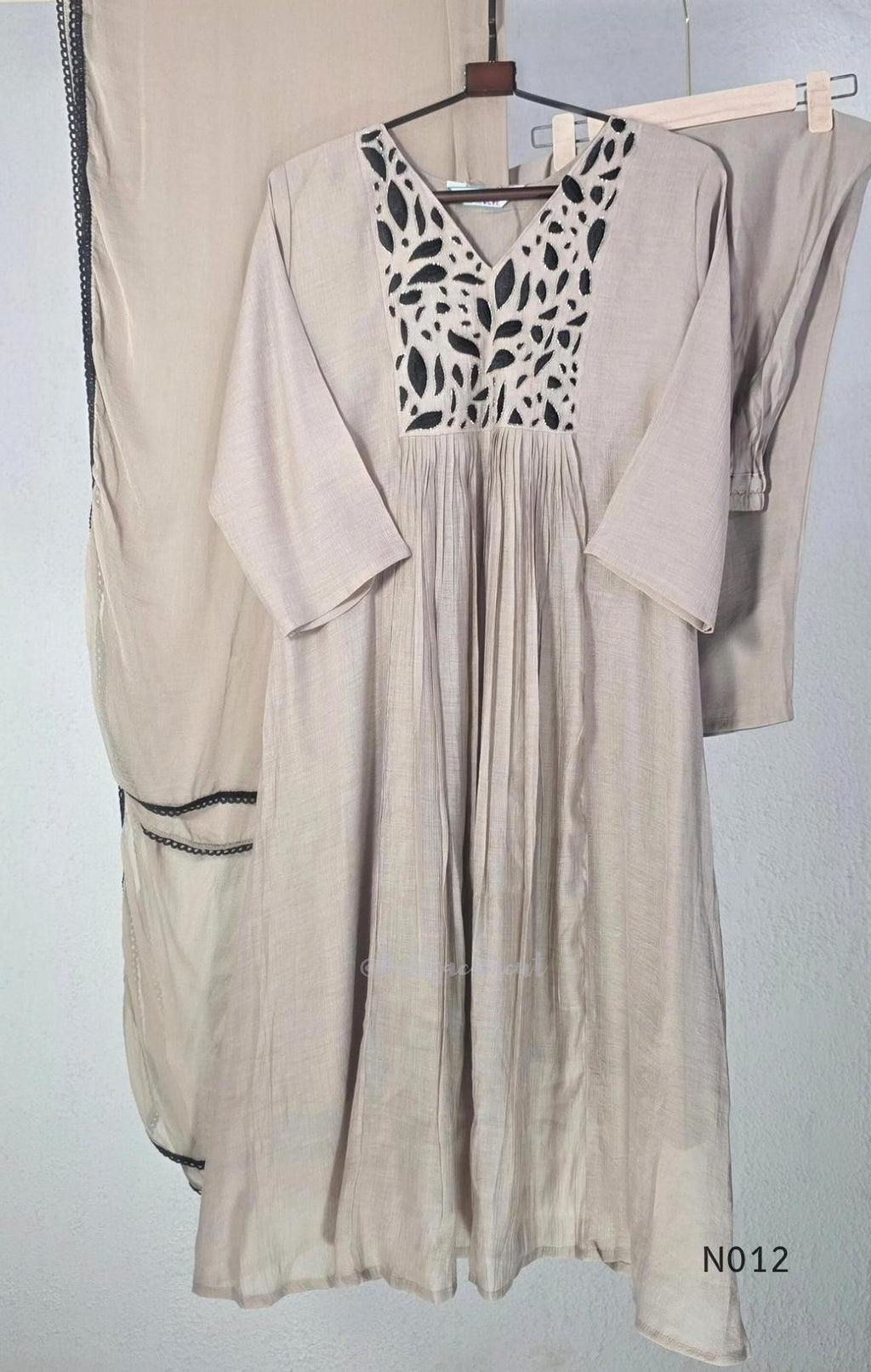 Muted ash-taupe Mul Chanderi churidar set with black leaf-pattern yoke, straight pants and matching bordered dupatta.