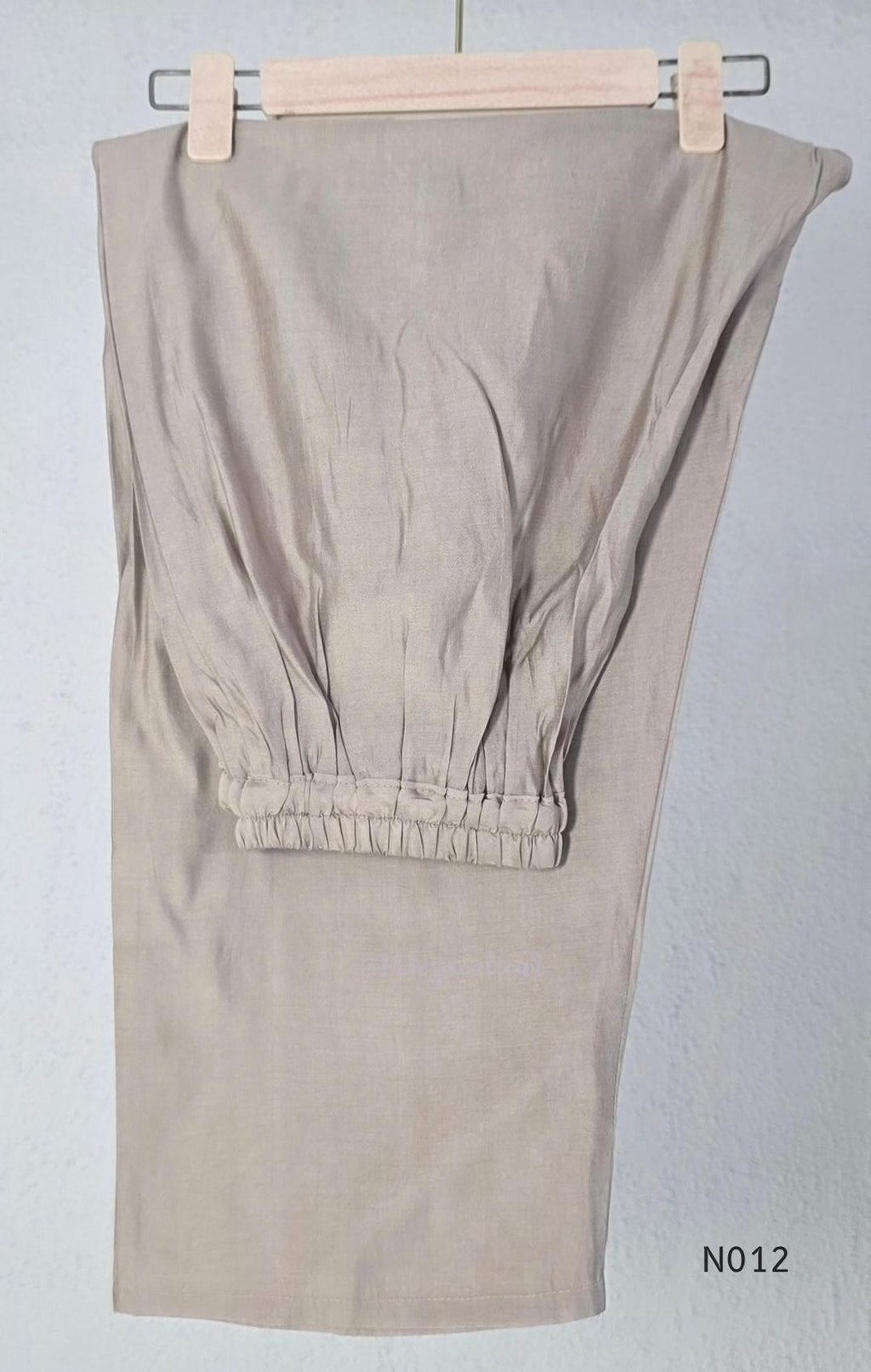 Muted ash-taupe Mul Chanderi churidar set with black leaf-pattern yoke, straight pants and matching bordered dupatta.