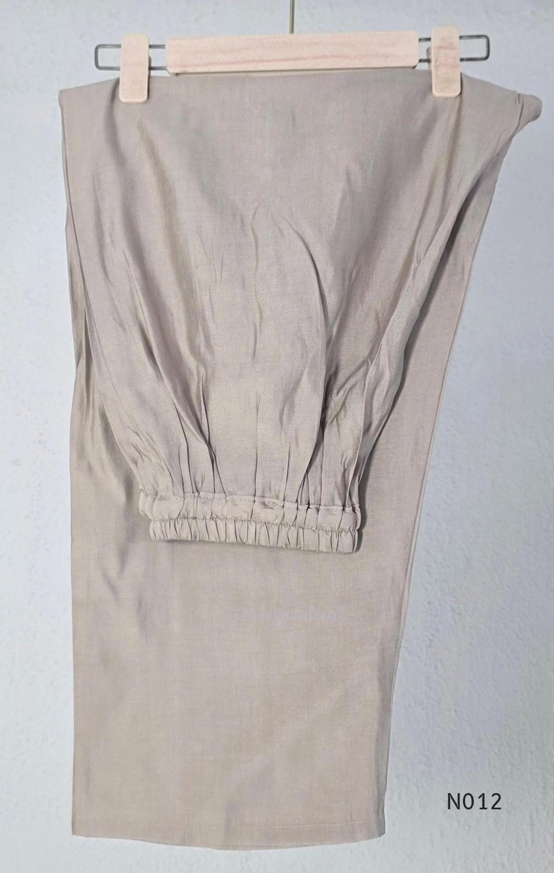 Muted ash-taupe Mul Chanderi churidar set with black leaf-pattern yoke, straight pants and matching bordered dupatta.