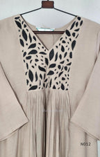 Muted ash-taupe Mul Chanderi churidar set with black leaf-pattern yoke, straight pants and matching bordered dupatta.