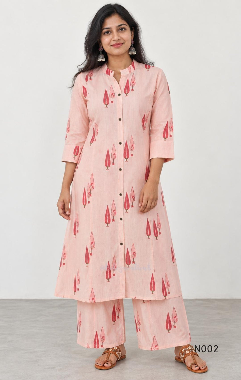 Soft peach cotton printed A-line button-front kurta with pink botanical motifs and matching wide-leg palazzo trousers.