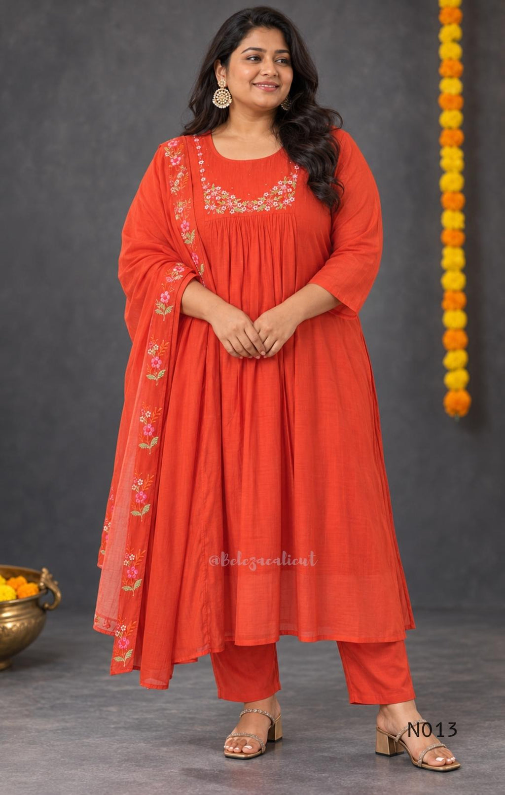 Vermilion-orange Mul Chanderi floral churidar set with a matching dupatta and straight-leg bottom.